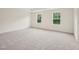 Spacious bedroom with neutral carpet flooring and natural light from windows at 92 Frost Meadow Way, Lillington, NC 27546