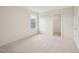 Neutral carpeted bedroom with a single window and access to a closet and another room at 92 Frost Meadow Way, Lillington, NC 27546