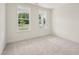 Well-lit bedroom featuring plush carpet, large windows overlooking a tree lined street at 92 Frost Meadow Way, Lillington, NC 27546