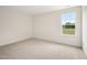 Carpeted bedroom with bright light walls and a single window with a beautiful green view outside at 92 Frost Meadow Way, Lillington, NC 27546