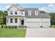Beautiful two-story home with a three-car garage and covered front porch at 92 Frost Meadow Way, Lillington, NC 27546