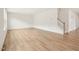 Spacious living room featuring hardwood floors, bright white walls, and staircase to upper level at 92 Frost Meadow Way, Lillington, NC 27546