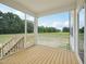 View of the screened porch with wood floors and railings at 92 Frost Meadow Way, Lillington, NC 27546