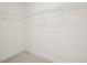 Spacious walk-in closet with ample shelving and neutral carpet; perfect storage solution at 92 Frost Meadow Way, Lillington, NC 27546