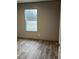 Bright bedroom with large window and wood-look floors at 1039 Branch Chapel Church Rd, Selma, NC 27576