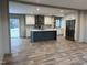 Modern kitchen with island, stainless steel appliances, and vinyl flooring at 1039 Branch Chapel Church Rd, Selma, NC 27576