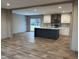 Modern kitchen with island, stainless steel appliances, and vinyl flooring at 1039 Branch Chapel Church Rd, Selma, NC 27576