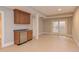 Basement wet bar with wood cabinets, granite countertop, and mini-fridge at 10825 Ashland Mill Ct, Raleigh, NC 27617