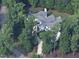 Aerial view of a grand home nestled among lush trees at 11201 Jonas Ridge Ln, Raleigh, NC 27613