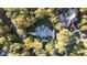 Stunning aerial view of an estate surrounded by lush trees, showcasing the home's privacy and landscaping at 11201 Jonas Ridge Ln, Raleigh, NC 27613