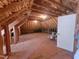 Unfinished attic space with exposed wooden beams and insulation, offering potential for customization at 11201 Jonas Ridge Ln, Raleigh, NC 27613
