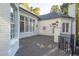 Inviting back deck with white brick and classic black iron railing at 11201 Jonas Ridge Ln, Raleigh, NC 27613
