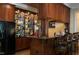 The bar area features custom cabinetry and a bar with seating at 11201 Jonas Ridge Ln, Raleigh, NC 27613