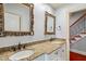 Elegant bathroom featuring double sinks, granite countertops and decorative framed mirrors at 11201 Jonas Ridge Ln, Raleigh, NC 27613