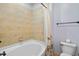 Clean, tiled bathroom with a shower-tub combo, white toilet, and modern fixtures at 11201 Jonas Ridge Ln, Raleigh, NC 27613