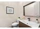 Modern powder room featuring a vessel sink, sleek faucet, and decorative mirror for a stylish and functional space at 11201 Jonas Ridge Ln, Raleigh, NC 27613