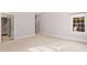 Spacious carpeted bedroom features natural light and access to a staircase through an open door at 11201 Jonas Ridge Ln, Raleigh, NC 27613