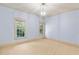 Inviting carpeted bedroom with light blue walls and large windows offering natural light at 11201 Jonas Ridge Ln, Raleigh, NC 27613