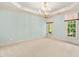 Bright, spacious bedroom with plush carpeting, elegant trim, and ample natural light from two large windows at 11201 Jonas Ridge Ln, Raleigh, NC 27613