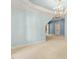 Light-filled room with neutral walls, soft carpet, elegant chandelier, and stylish trim, offering a versatile space at 11201 Jonas Ridge Ln, Raleigh, NC 27613