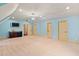 Spacious bonus room with a wet bar, TV, and neutral carpet, offers versatile living and entertainment options at 11201 Jonas Ridge Ln, Raleigh, NC 27613