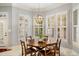 Bright breakfast nook with a wood table and white shutters at 11201 Jonas Ridge Ln, Raleigh, NC 27613