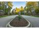 Gated community entrance with landscaping and stone pillars at 11201 Jonas Ridge Ln, Raleigh, NC 27613