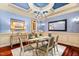 Bright dining room with a glass-top table and stunning chandelier at 11201 Jonas Ridge Ln, Raleigh, NC 27613