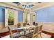 Formal dining room with blue walls, plantation shutters and chandelier at 11201 Jonas Ridge Ln, Raleigh, NC 27613