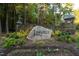 Linville community entrance with stone gatehouse and lush landscaping at 11201 Jonas Ridge Ln, Raleigh, NC 27613