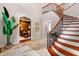 Bright entryway with a curved staircase and view of home office at 11201 Jonas Ridge Ln, Raleigh, NC 27613