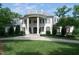 Stunning two-story home with classic columns and white brick facade at 11201 Jonas Ridge Ln, Raleigh, NC 27613