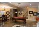 Spacious entertainment room featuring a pool table and access to a staircase and dining area at 11201 Jonas Ridge Ln, Raleigh, NC 27613