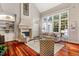 Living room with large stone fireplace and hardwood floors at 11201 Jonas Ridge Ln, Raleigh, NC 27613