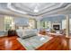 Luxurious main bedroom with hardwood floors, fireplace and sitting area at 11201 Jonas Ridge Ln, Raleigh, NC 27613