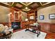 Spacious home office with built-in shelving and fireplace at 11201 Jonas Ridge Ln, Raleigh, NC 27613