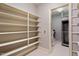Walk-in pantry with ample shelving for food storage and laundry area at 11201 Jonas Ridge Ln, Raleigh, NC 27613