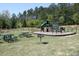 Community playground featuring a slide, climbing structures, and picnic tables at 11201 Jonas Ridge Ln, Raleigh, NC 27613