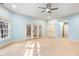Room featuring a ceiling fan, multiple windows, and neutral carpet perfect for relaxation at 11201 Jonas Ridge Ln, Raleigh, NC 27613