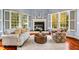 Bright sitting area with fireplace, hardwood floors and large windows at 11201 Jonas Ridge Ln, Raleigh, NC 27613