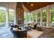 Sunroom with stone fireplace and ample natural light at 11201 Jonas Ridge Ln, Raleigh, NC 27613