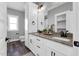 Bright bathroom featuring a double vanity with granite countertops, modern fixtures, and dark wood-style flooring at 1178 Sheriff Johnson Rd, Lillington, NC 27546