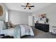 Cozy bedroom with a ceiling fan, grey walls, carpet, and a dark wood dresser at 1178 Sheriff Johnson Rd, Lillington, NC 27546