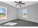 Empty bedroom with two large windows, grey walls, and carpeted flooring at 1178 Sheriff Johnson Rd, Lillington, NC 27546