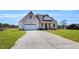 Beautiful home exterior with a two-car garage and a long driveway, set against a green lawn at 1178 Sheriff Johnson Rd, Lillington, NC 27546