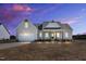 Beautiful single-story home showcasing a side-entry garage and inviting front porch at 1178 Sheriff Johnson Rd, Lillington, NC 27546