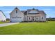 Charming home featuring a two-car garage, well-manicured lawn, and inviting front porch at 1178 Sheriff Johnson Rd, Lillington, NC 27546
