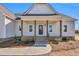 Inviting front porch with brick steps and wooden pillars at 1178 Sheriff Johnson Rd, Lillington, NC 27546