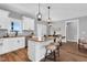 Open kitchen boasts a breakfast bar, stainless steel appliances, granite countertops, and modern pendant lighting at 1178 Sheriff Johnson Rd, Lillington, NC 27546