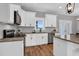 Bright kitchen features custom white cabinets, granite countertops, and modern stainless steel appliances at 1178 Sheriff Johnson Rd, Lillington, NC 27546